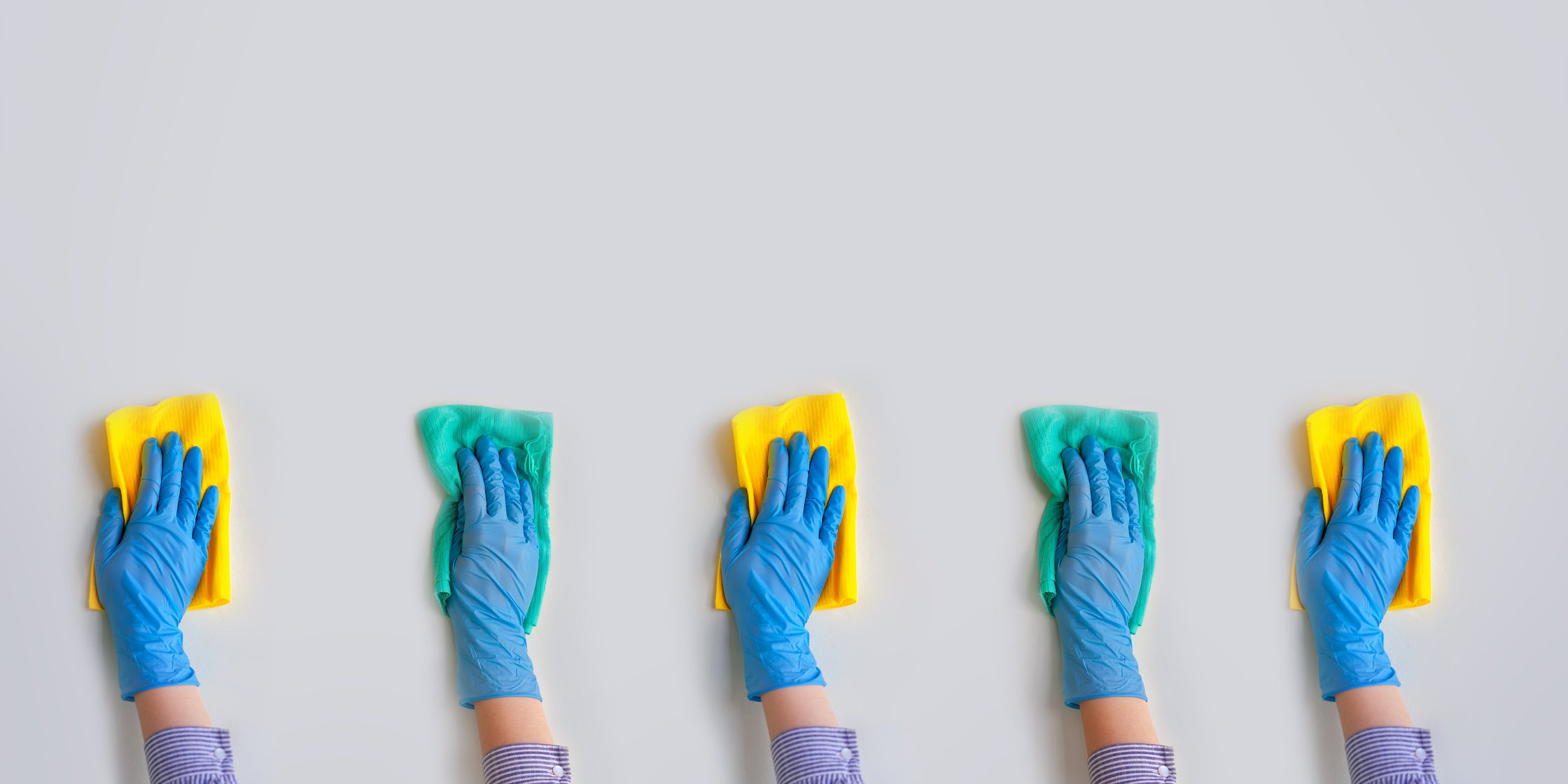 Commercial cleaning company. Employee hands in blue rubber protective glove. General or regular cleanup.